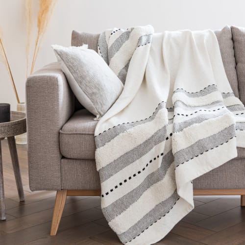 Ecru Fringed Cotton Throw with Black and Grey Graphic Motifs .