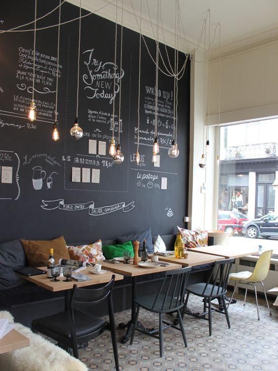 Modern and cheerful coffee shop decor with a chalkboard wa .