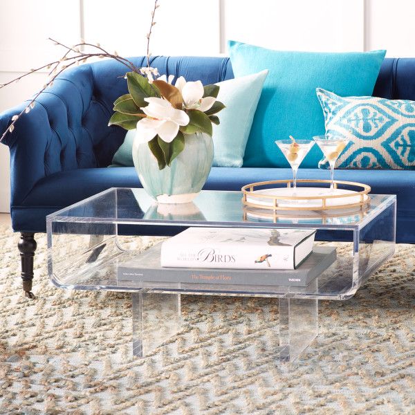 The Modern Acrylic Coffee Table features an expansive table top .