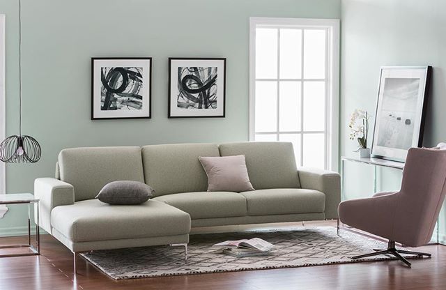 The sleek profile of this tuxedo style sectional is ideal for home .