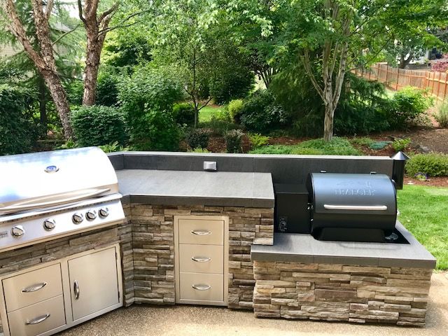 Traeger smoker outdoor kitchen by Sunset Outdoor Living, LLC .