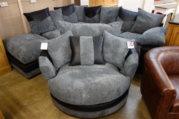 A Dino black fabric corner sofa and Dina black fabric swivel chair .