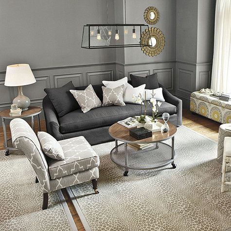 Room from Ballard Designs -- charcoal sofa with upholstered accent .